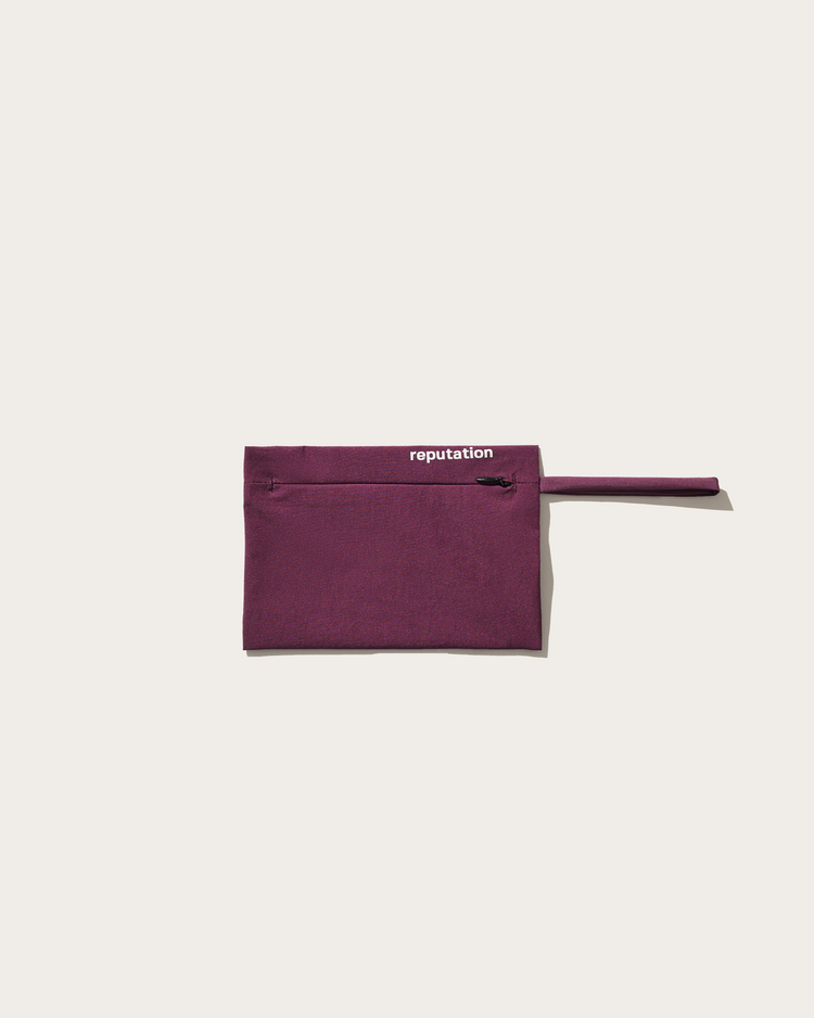 Reputation noir plum swimwear packaging pouch, flat lay
