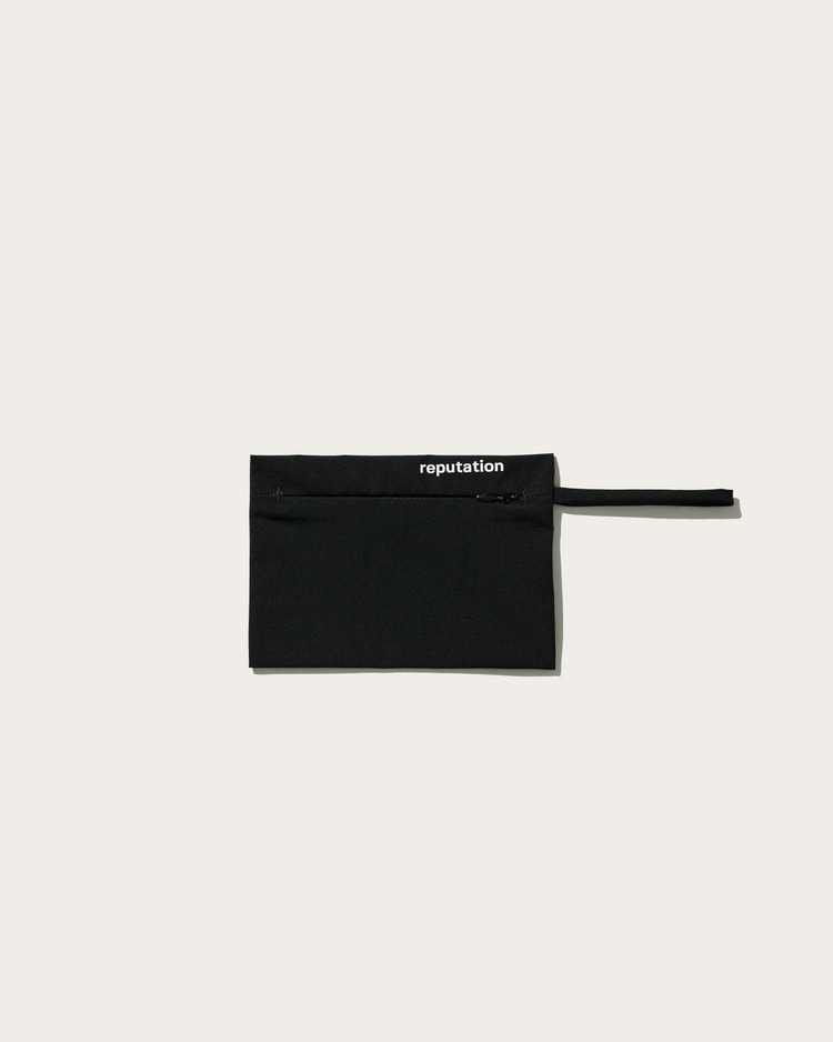 Reputation black swimwear packaging pouch, flat lay